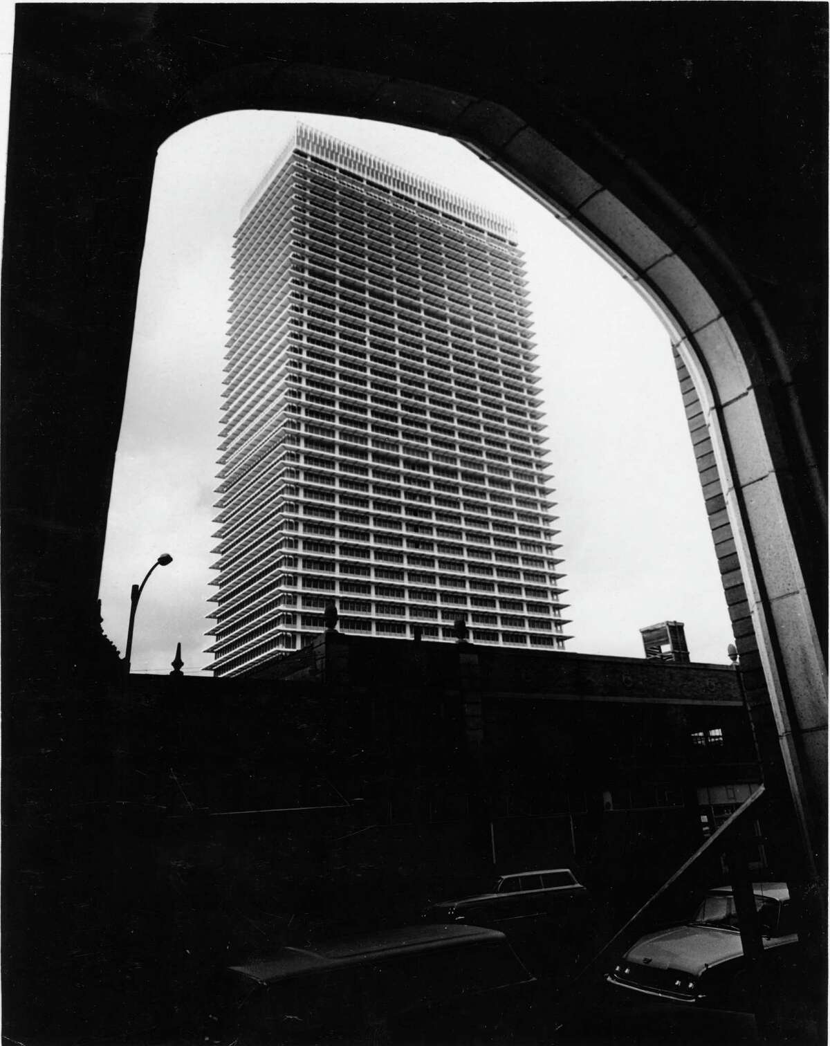 The Humble Oil skyscraper was an immediate landmark. From the Chronicle files. The caption from November 1962: "Framed by an archway of the First Methodist Church at 1320 Main, the Humble Building, at 800 Bell, fills the sky. The building's distinctive cantilevered skin is already familiar to Houstonians."