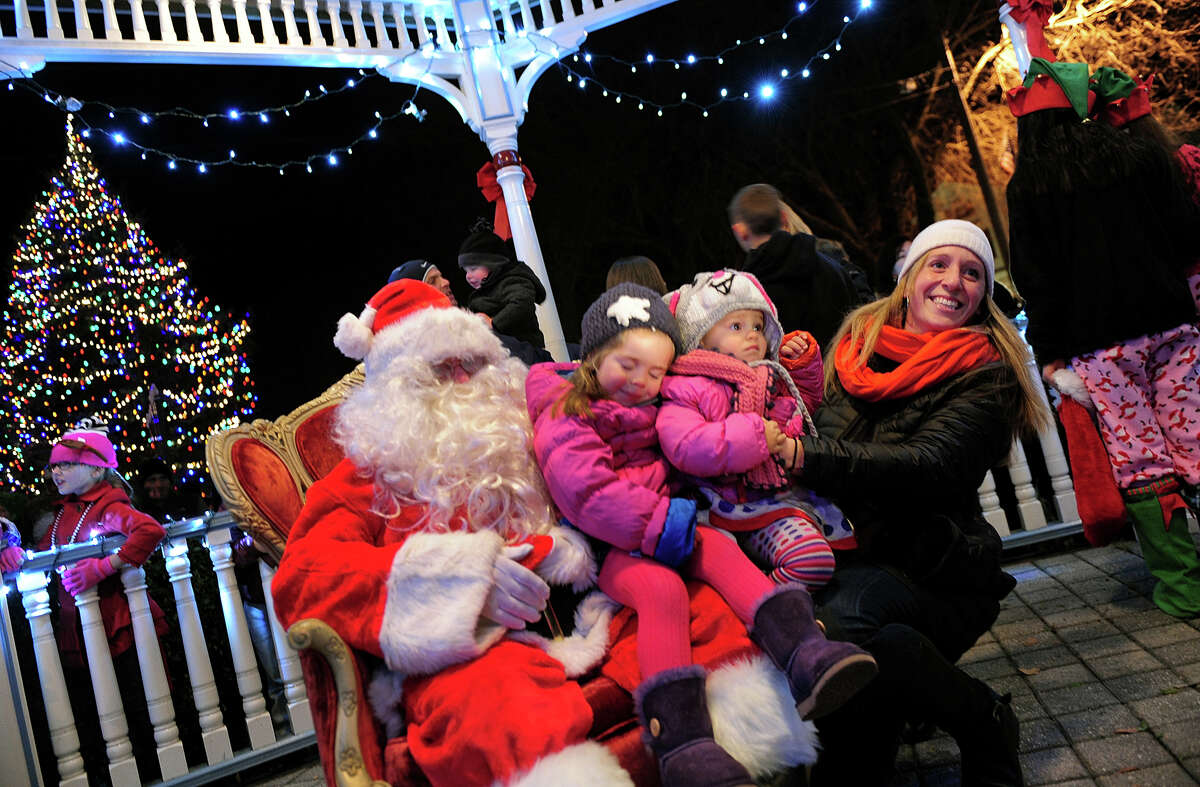 Calliope and Thalia Barry, 3, and 1, of Milford, visit Santa Claus with their mom Marin, during the annual Festival of Lights and Tree Lighting on the historic Milford Green in Milford, Conn. on Friday November 29, 2013.