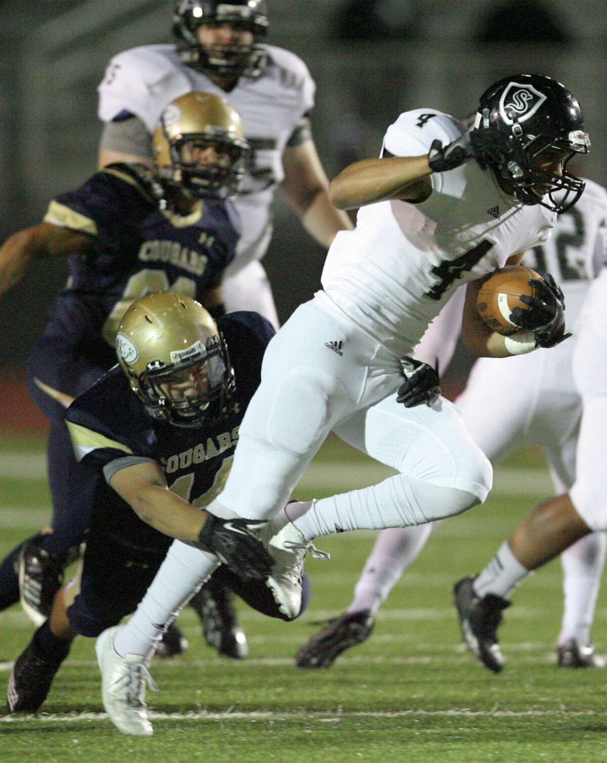 Steele's Justin Stockton tries to break free from Edinburg North Joel Guerrero during first quarter play at Cabiniss Field in Corpus Christi on Friday, Nov. 29, 2013.