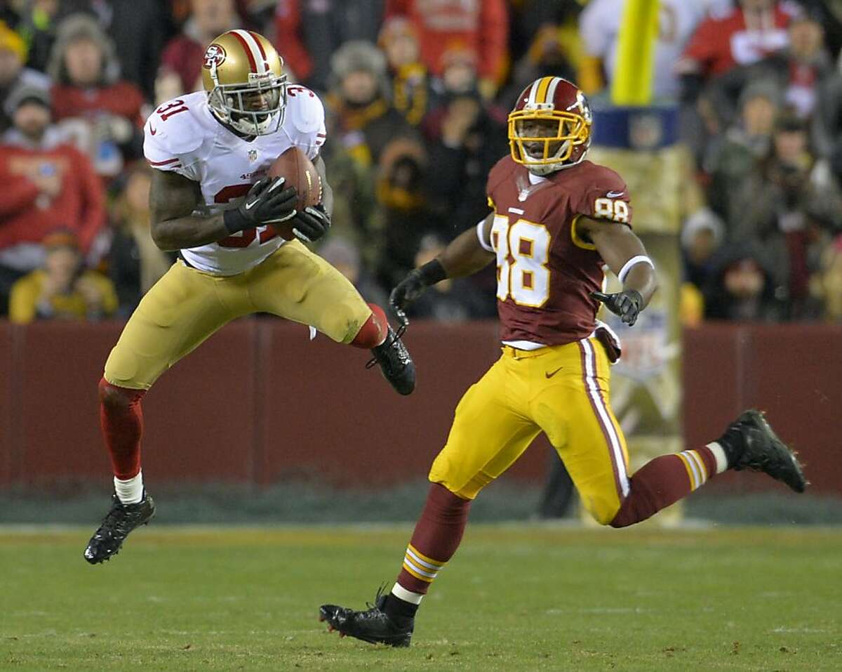San Francisco 49ers strong safety Donte Whitner (31) intercepts a pass in front of Washington Redskins wide receiver Pierre Garcon (88) in the first quarter at FedEx Field in Landover, Maryland, Monday, November 25, 2013. (Doug Kapustin/MCT)