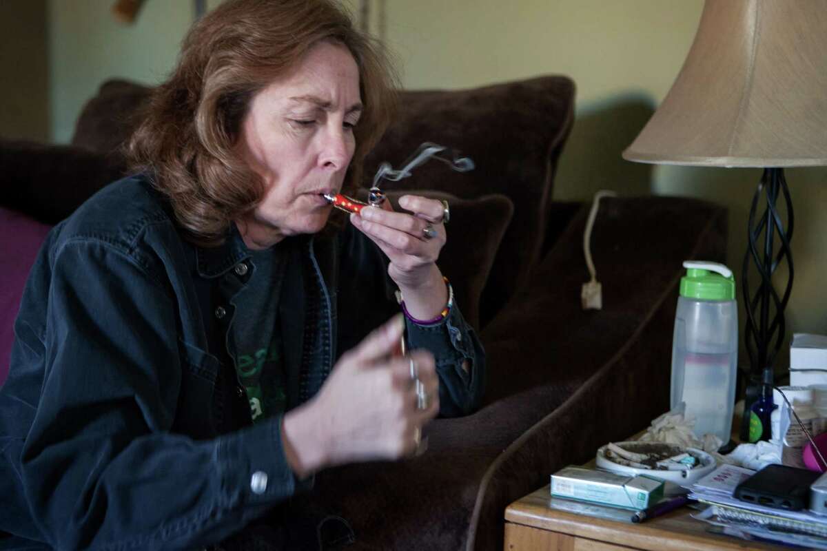 11/26/13 2:30:30 PM -- Albuquerque NM -- Yvette McClelland smokes prescription medical cannabis at her home in Albuquerque NM. -- Photo by Steven St John