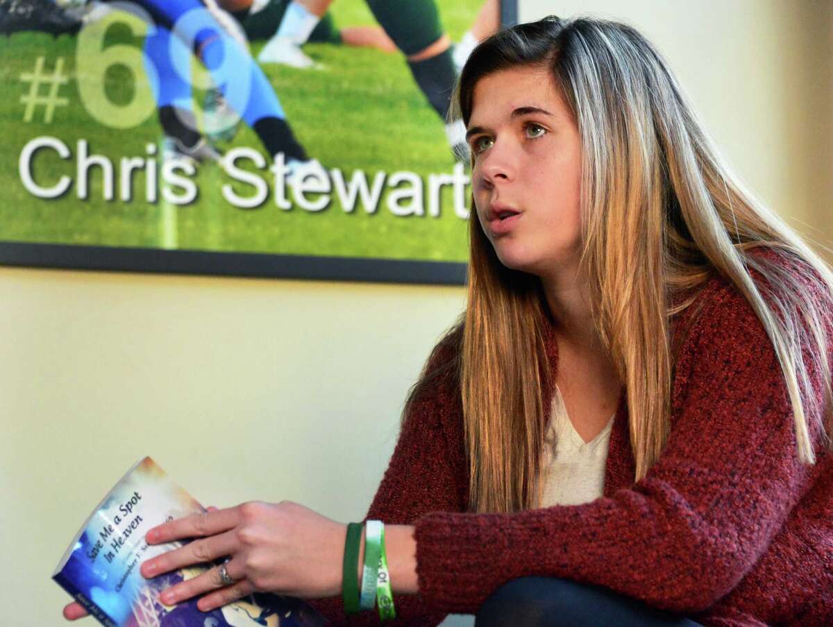 Bailey Wind, a survivor of last December's Northway accident, holds her book as she speaks about her life since the accident during an interview at her family's home Friday Nov. 29, 2013, in Colonie, NY. (John Carl D'Annibale / Times Union)