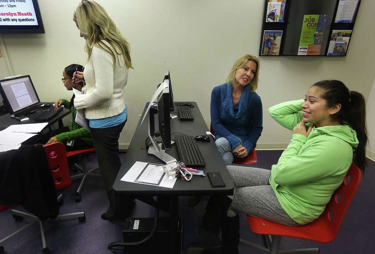 Elaine Hartle, second from right, Director of THRU Project, helps Jessica Urias, right, 19, with an online application form, at PAL Aftercare. Monday, Nov. 25, 2013. Stacy Lee, second from left, BCFS Program Director of PAL Aftercare, assists Jessica Francis with a questionaire.