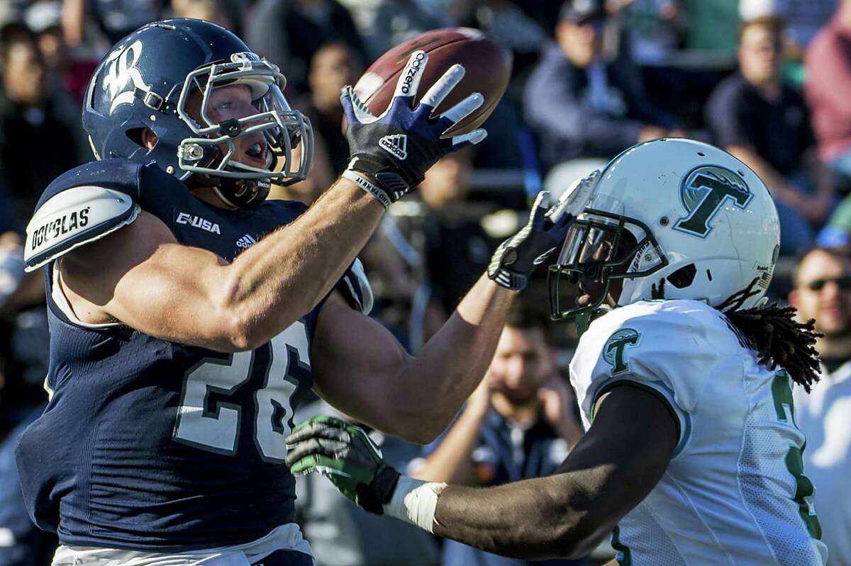 Rice running back Turner Petersen catches a 19-yard touchdown pass over Tulane safety Darion Monroe in the first quarter. Petersen left in the second quarter with a knee injury.