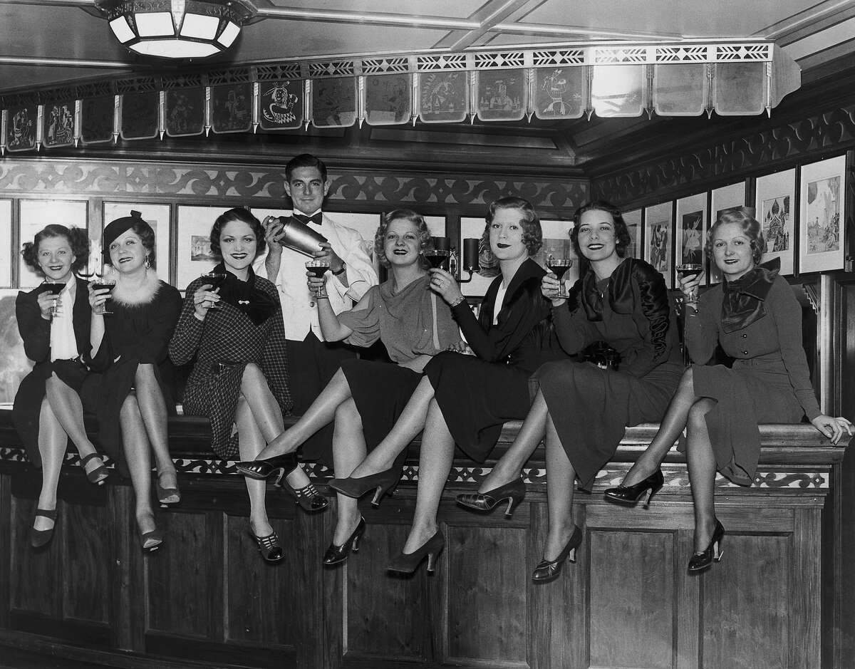 A group of young women at the bar on board the luxury liner SS Manhattan, off New York, 5th December 1933. Before the repeal of prohibition, the ship's bar was required to close 12 miles out from the US coast.