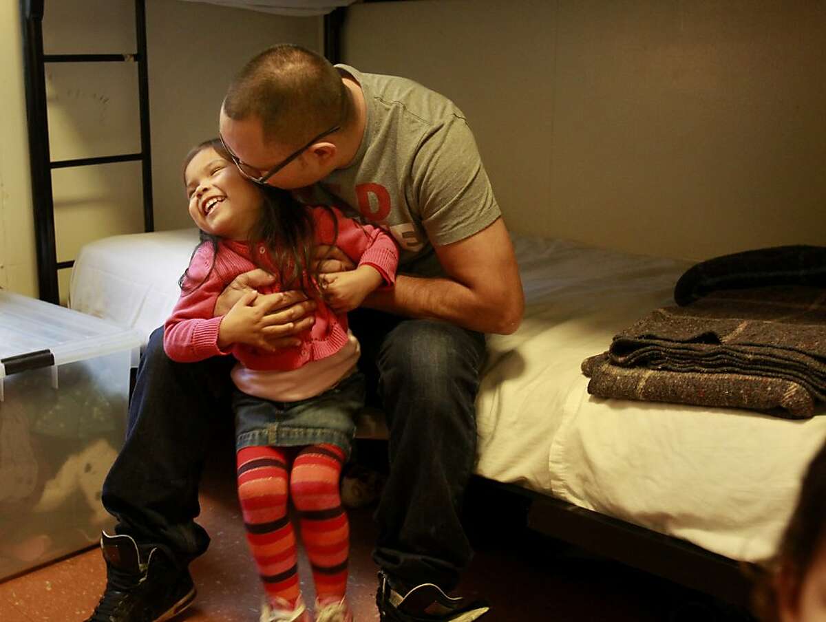 Christopher Ramirez gave his daughter Emily Grace a kiss in the room they live in at the Hamilton Family Residence Wednesday November 20, 2013 in San Francisco, Calif. The Ramirez family, after years of homelessness and living in shelters, won a lottery and will soon move into a brand new apartment on Market Street.