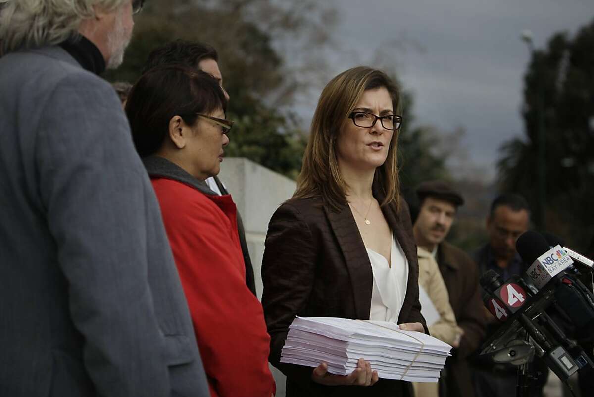 Kerianne Steele (right), attorney for SEIU 1021, speaks during a press conference announcing the filing of a lawsuit against the BART board of directors over a contract dispute outside the Rene C. Davidson Courthouse on Tuesday, December 3, 2013 in Oakland, Calif.