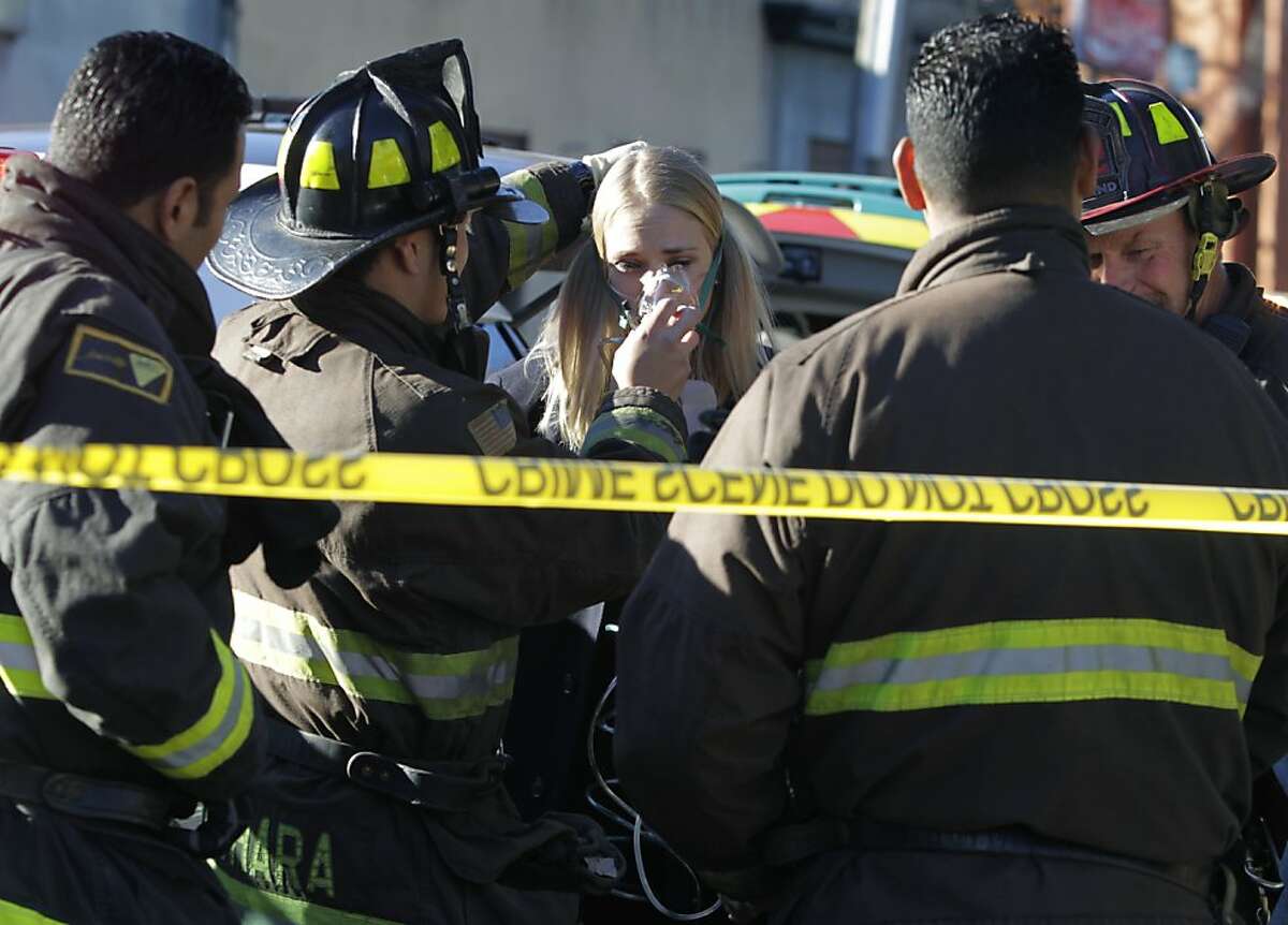 Firefighters treat an injured passenger at the Rockridge BART station in Oakland, Calif. on Wednesday, Dec. 4, 2013 after a westbound train became stranded in the Berkeley Hills tunnel. Several commuters were transported to local hospitals.