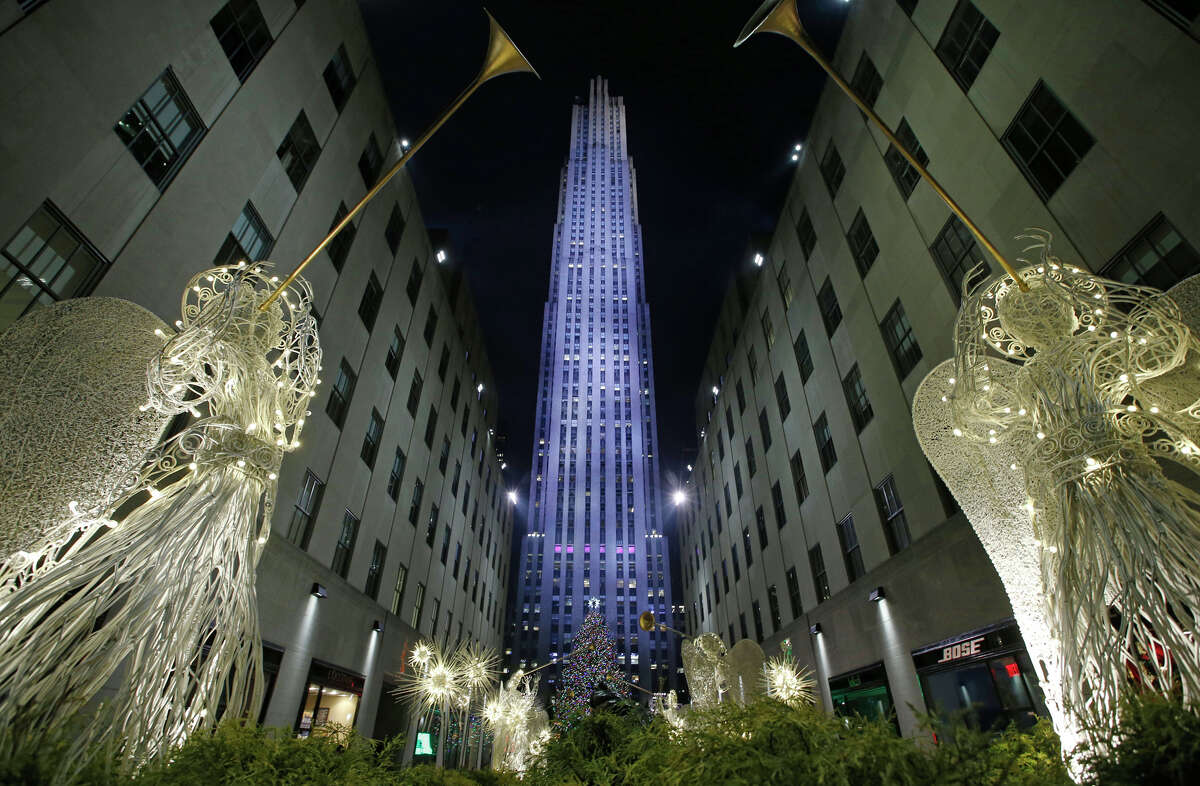 Angels made of wire and light frame the Rockefeller Center Christmas tree after it was lit during a ceremony, Wednesday, Dec. 4, 2013, in New York. Some 45,000 energy efficient LED lights adorn the 76-foot tree.
