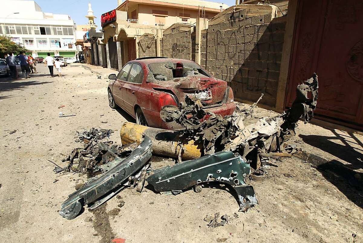 A destroyed car and the remains of car bomb are seen following an explosion outside the Swedish consulate in the eastern Libyan city of Benghazi on October 11, 2013 which seriously damaged the building but caused no casualties. The Swedish mission is one of the few remaining diplomatic offices remaining in Benghazi, which was the cradle of uprising and frequently sees attacks on security personnel and institutions.