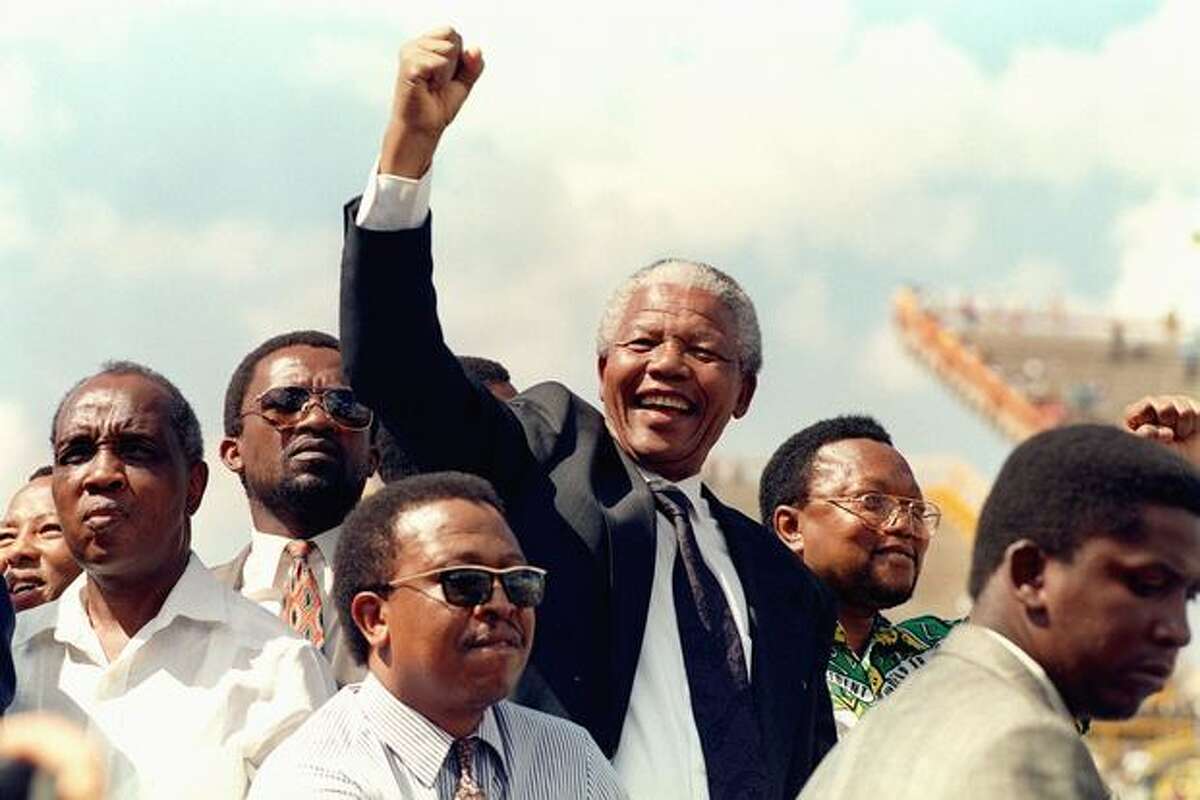 South African National Congress (ANC) President Nelson Mandela gives 15 March 1994 a clenched fist to supporters upon his arrival for his first election rally for 27 April general elections.