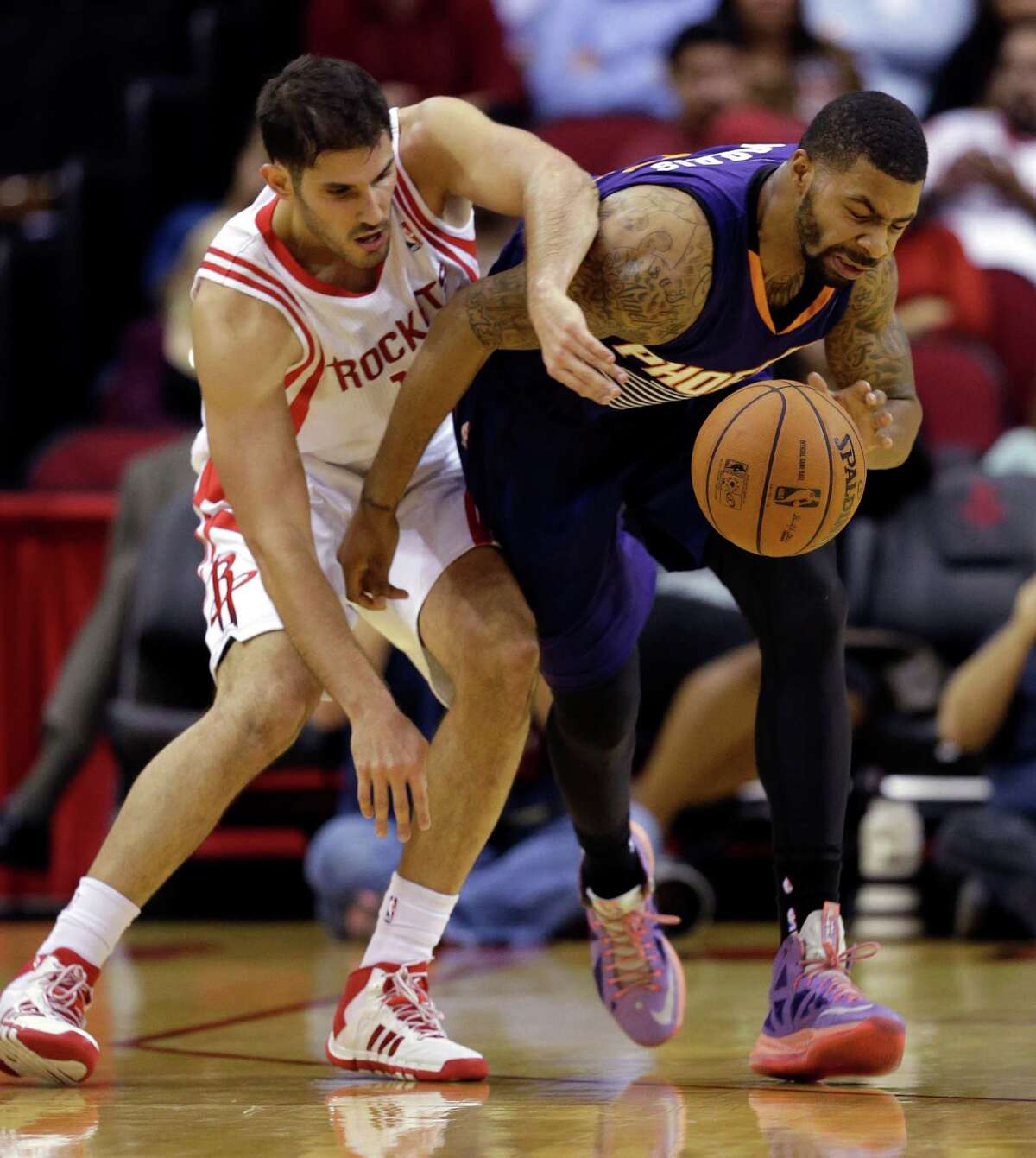 Phoenix Suns' Marcus Morris, right, steals the ball from Houston Rockets' Omri Casspi, left, during the second quarter of an NBA basketball game Wednesday, Dec. 4, 2013, in Houston. (AP Photo/David J. Phillip)