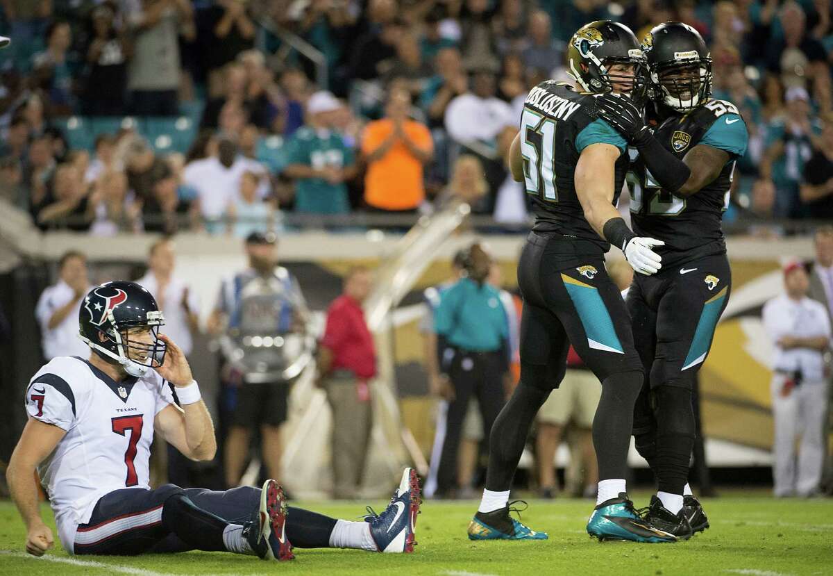 Texans quarterback Case Keenum takes a seat after a hit by Jaguars linebackers Paul Posluszny (51) and Geno Hayes (55) in the first quarter. Coach Gary Kubiak showed Keenum to a more permanent one in the third.