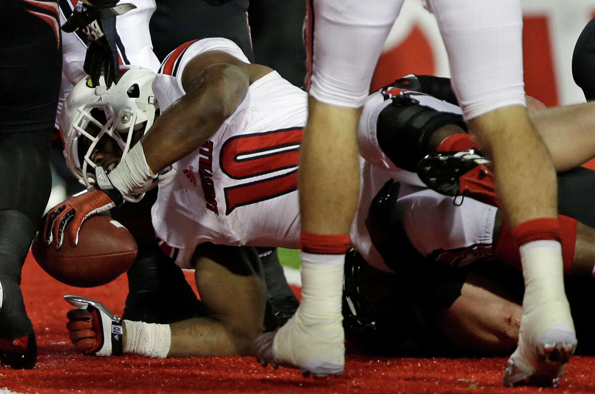 Louisville running back Dominique Brown falls into the end zone, giving the Cardinals the lead and eventual win in overtime.