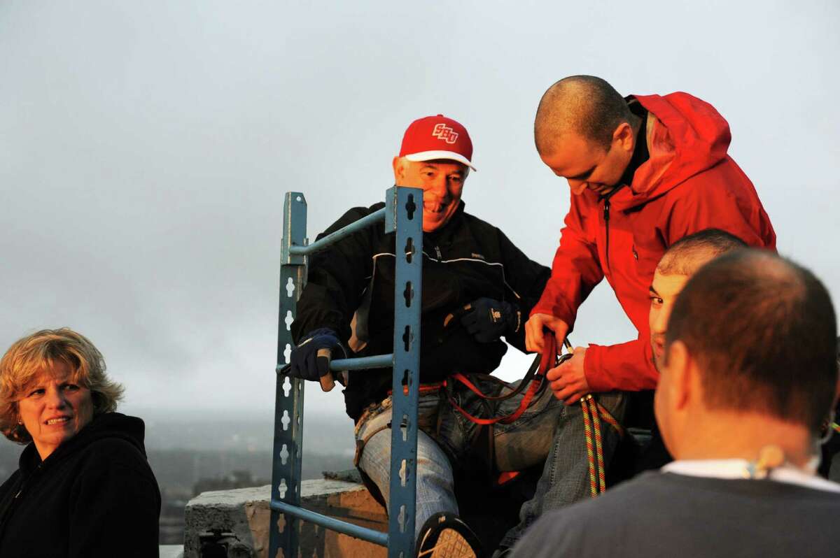 Bobby Valentine, Athletic Director at Sacred Heart University, prepares to rappel from the one of Stamford, Conn's tallest buildings One Landmark Square on Friday December 6, 2013.