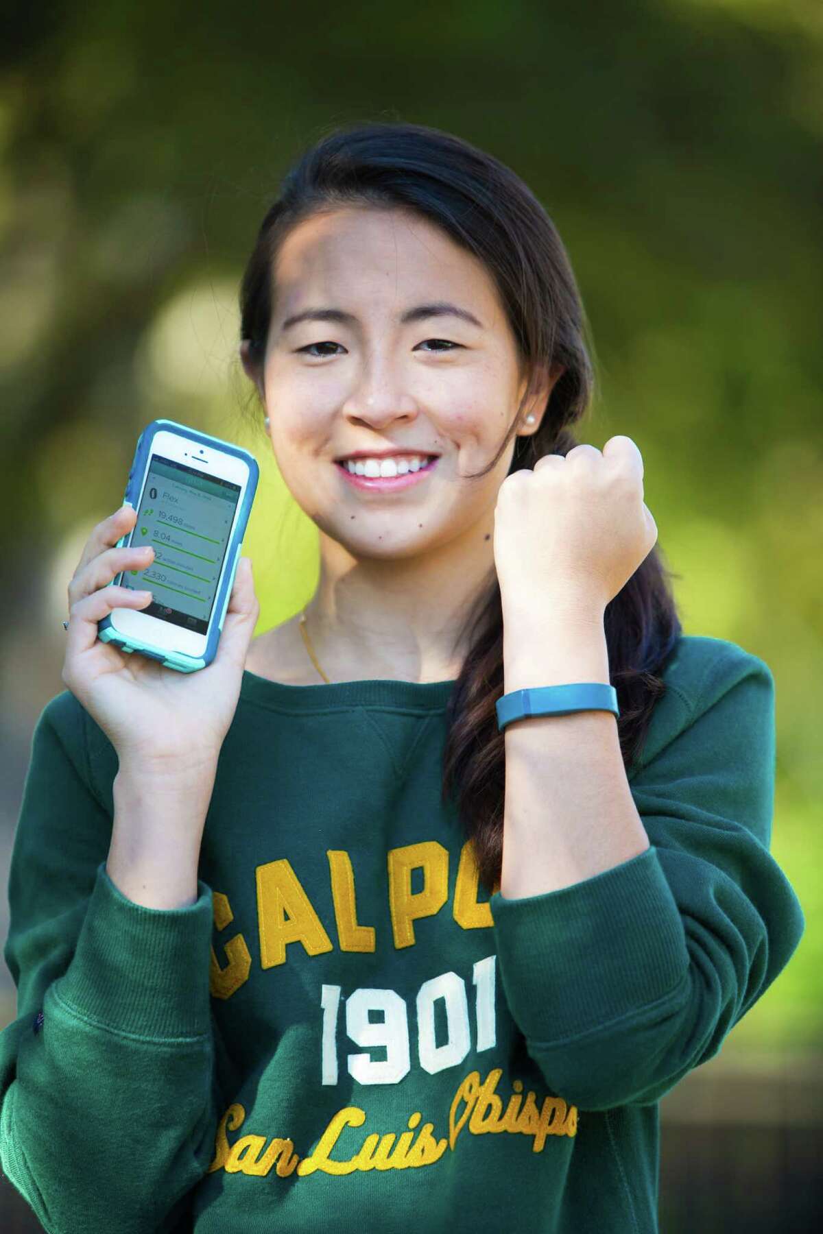 Allison Ying, 20, uses a Fitbit wristband to keep track of her daily steps, sleep and other fitness info. In fact, because of her influence, now her whole family uses the Fitbit. Friday, Nov. 29, 2013, in Houston. ( Marie D. De Jesus / Houston Chronicle )