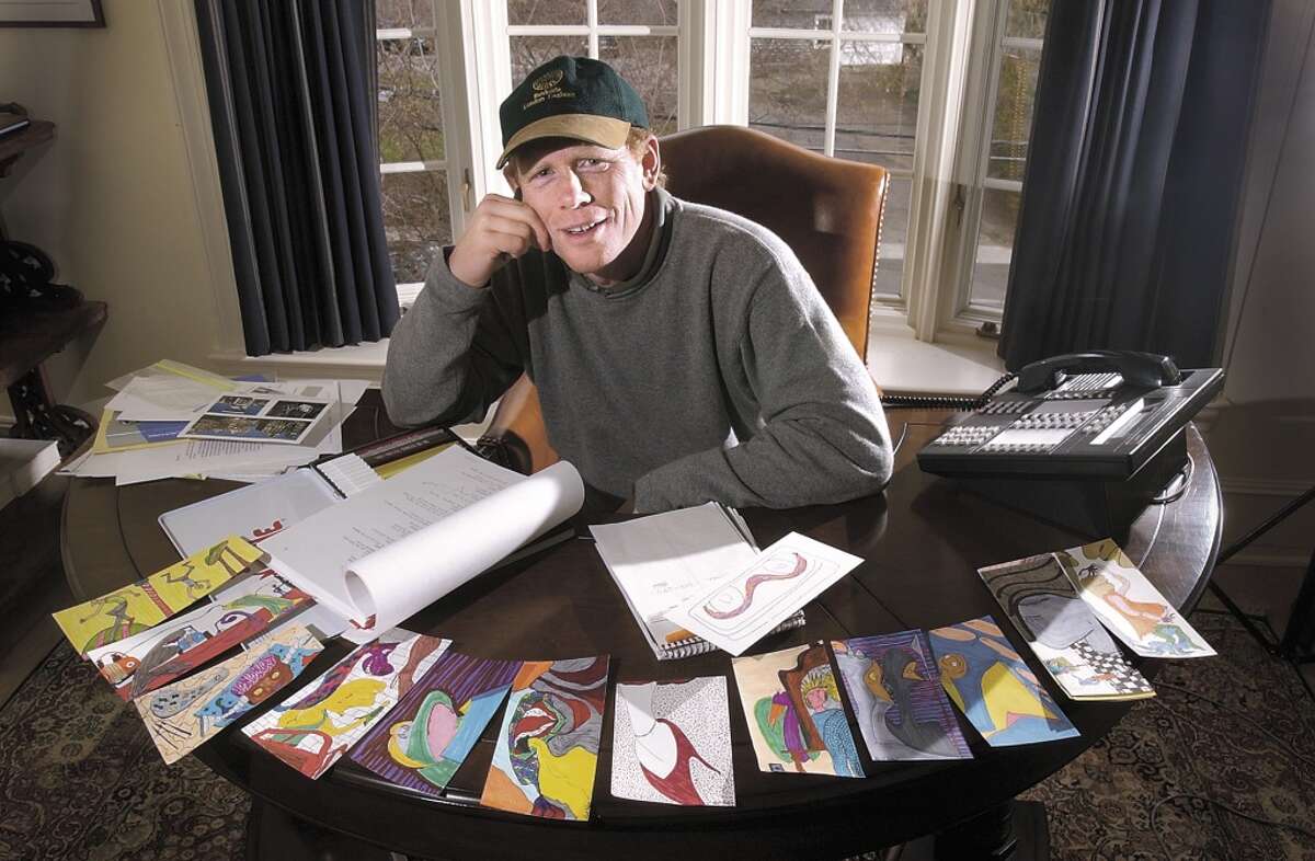 Oscar-winning director Ron Howard, of Greenwich, poses in his Greenwich office with a series of color doodles. Howard says he doodles to help his creativity and he says he doodles when he is talking on the phone. Howard says he spends a lot of time talking on the phone to people in the movie industry. (2002 file photo by Bob Luckey)