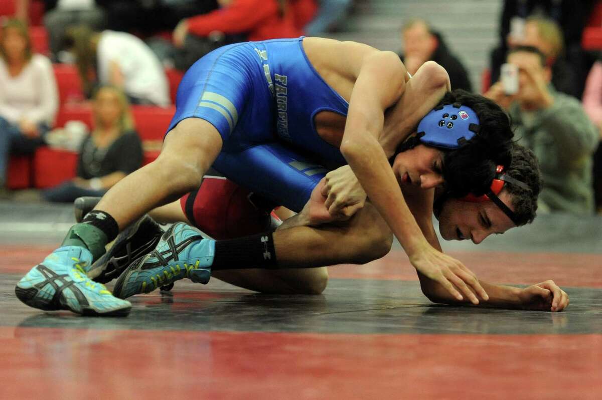 Fairfield Ludlowe's Eric Kirchgasser and Warde's Dylan Bender wrestle during Wednesday's match at Fairfield Warde High School.