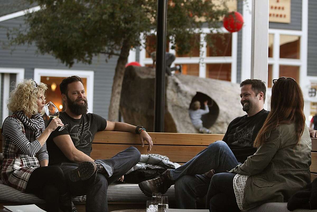 Left to right-- DeNai Jones, Braden Jones (left) chats with his brother Travis Jones and Karen Jones (right) at the outside seating area of Farmshop in the courtyard at the Marin Country Mart in Larkspur, Calif., on Friday, November 22, 2013.
