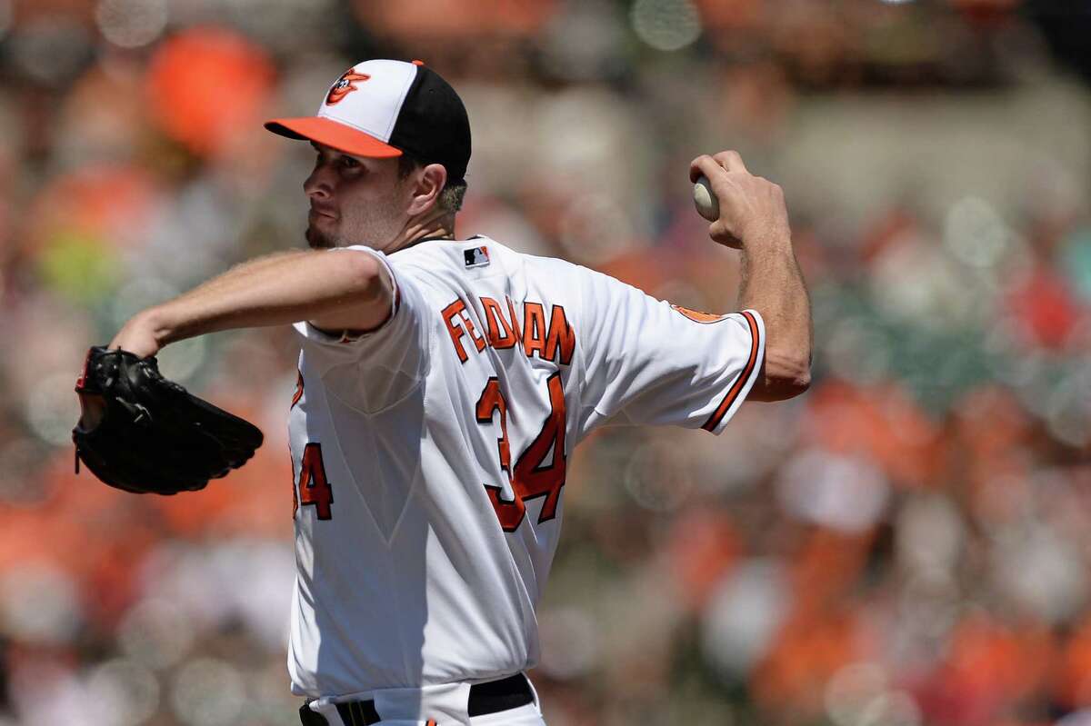 BALTIMORE, MD - AUGUST 25: Pitcher Scott Feldman #34 of the Baltimore Orioles pitches in the first inning against the Oakland Athletics at Oriole Park at Camden Yards on August 25, 2013 in Baltimore, Maryland. (Photo by Patrick Smith/Getty Images)