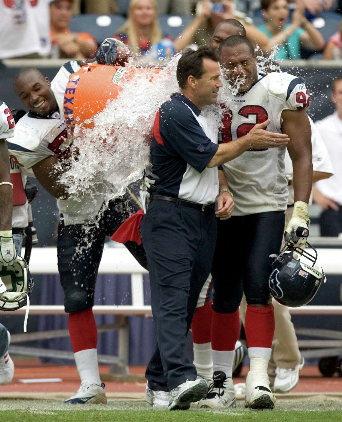 Gary Kubiak, center, enjoys splashdown courtesy of DeMeco Ryans, left, Mario Williams and Anthony Weaver during their first win of the season in 2006.