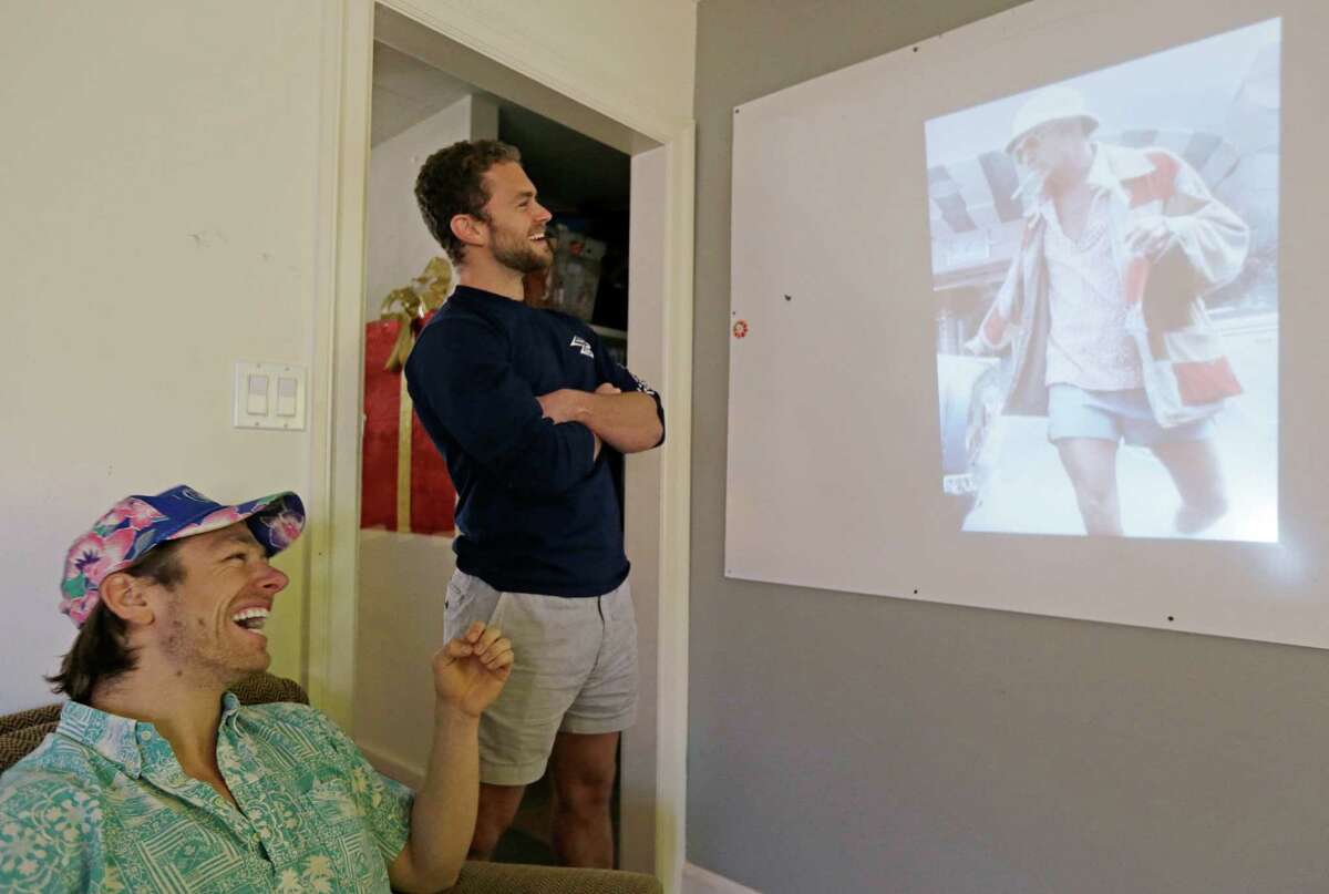 In this photo taken Wednesday, Dec. 4, 2013, co-founders Preston Rutherford, left, and Tom Montgomery, right, review user generated content for the upcoming week's social posts at the headquarters of Chubbies Shorts in San Francisco. Chubbies uses Facebook for marketing tools like videos that users will share with their friends. It uses Twitter for conversations with customers, and posts photos on Instagram to create buzz about their products. (AP Photo/Eric Risberg)