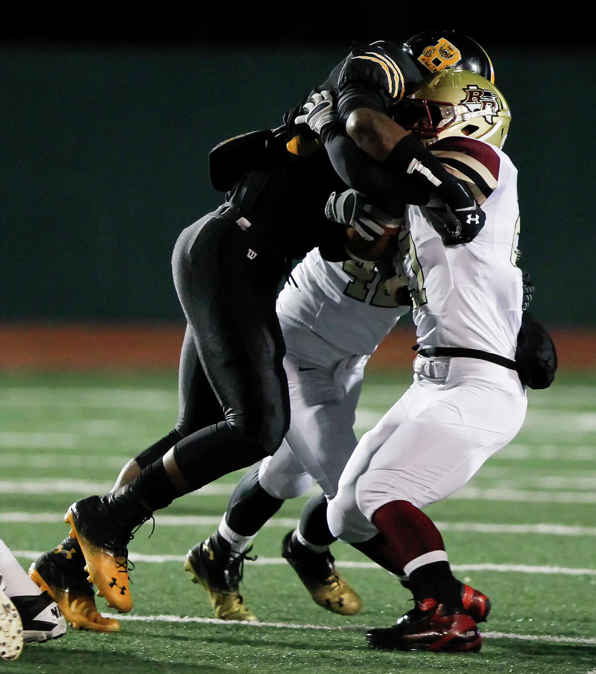 Brennan's Derick Roberson (left) stops Leander Rouse's Kevin Cole during the first half of their Class 4A Division I state quarterfinal game at Comalander Stadium on Friday, Dec. 6, 2013. MARVIN PFEIFFER/ mpfeiffer@express-news.net
