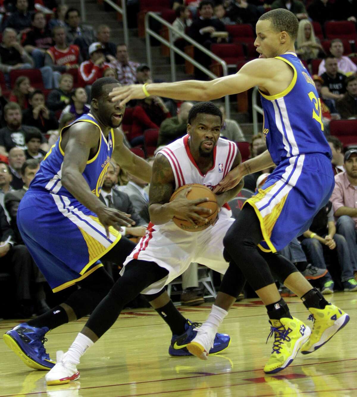 Aaron Brooks, center, did his best to elude the pressure applied by Draymond Green, left, and Stephen Curry in the Rockets' rout of the Warriors on Friday.