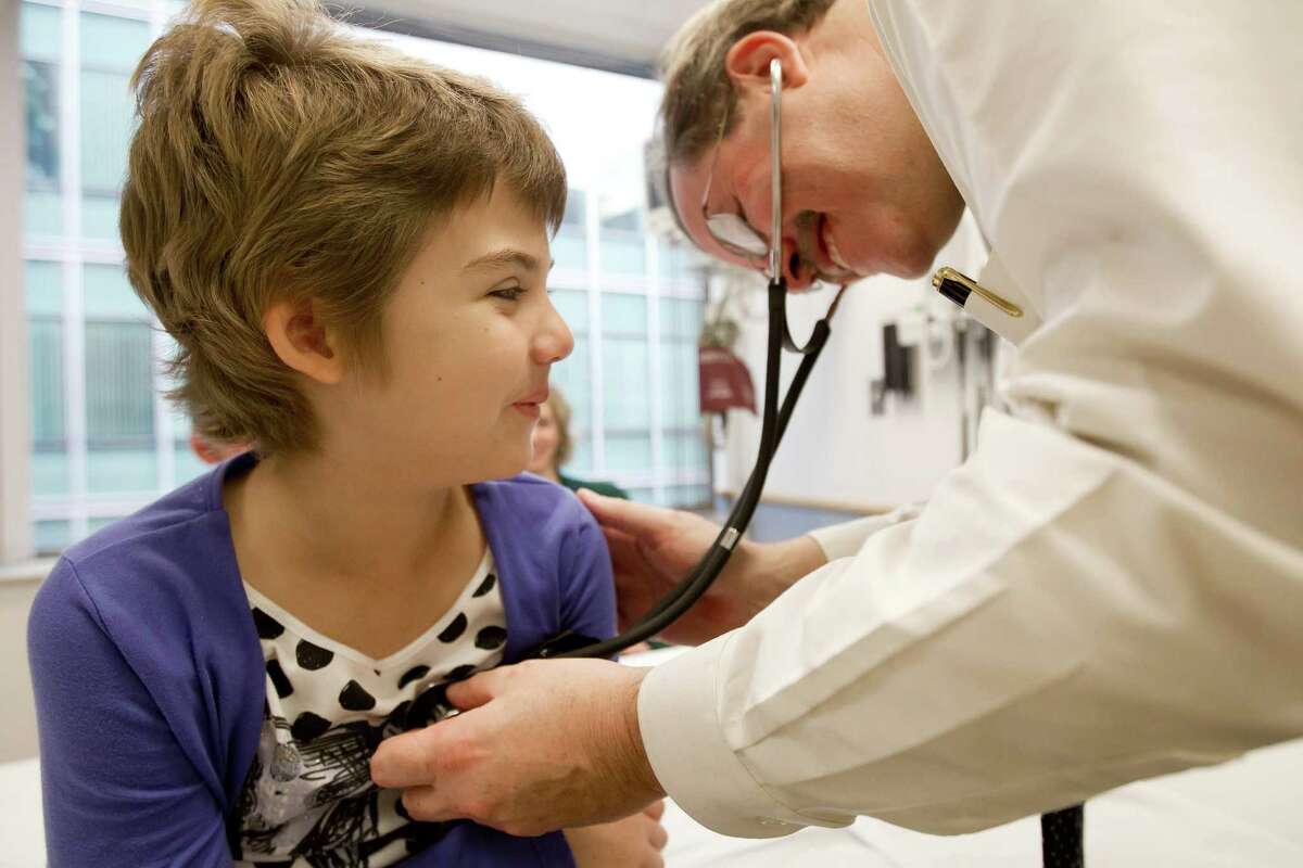 In this October 2012 photo provided by The Childrenâs Hospital of Philadelphia, Emily Whitehead is checked by pediatric oncologist, Dr. Stephan A. Grupp, at the hospital. In early 2012, she was the first child given gene therapy for acute lymphocytic leukemia and shows no sign of cancer today, nearly 21 months after. (AP Photo/The Children's Hospital of Philadelphia, Ed Cunicelli)