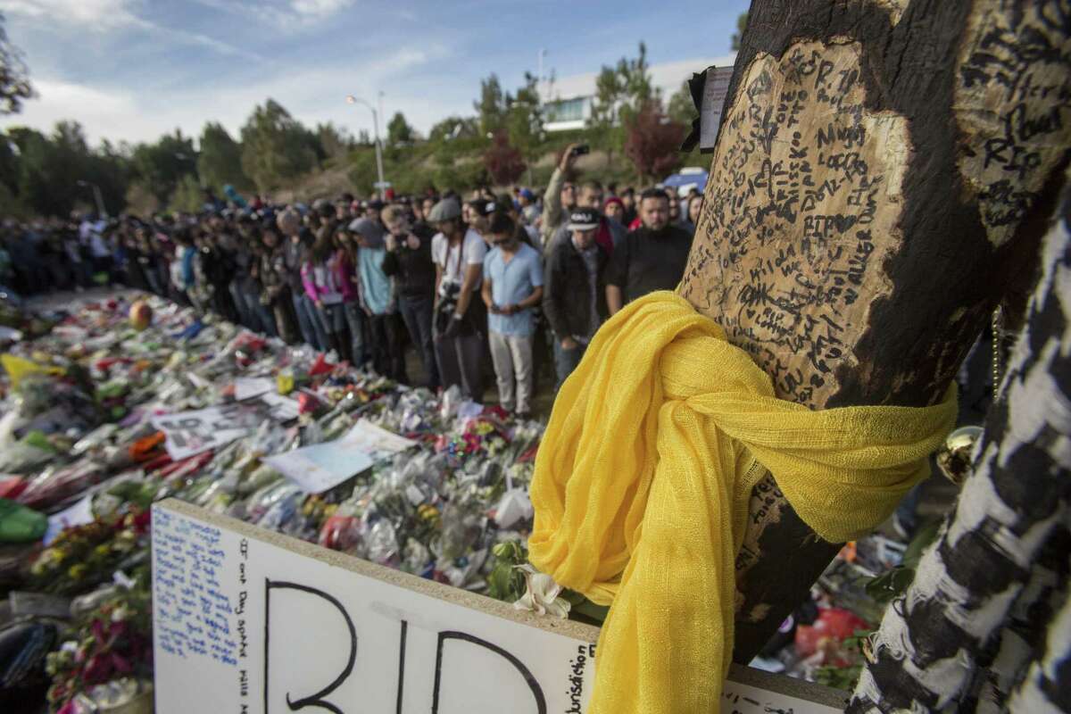 Messages on a tree are seen at a memorial rally for actor Paul Walker, who died with his friend Roger Rodas on Nov. 30 in a car crash in Valencia, Calif.