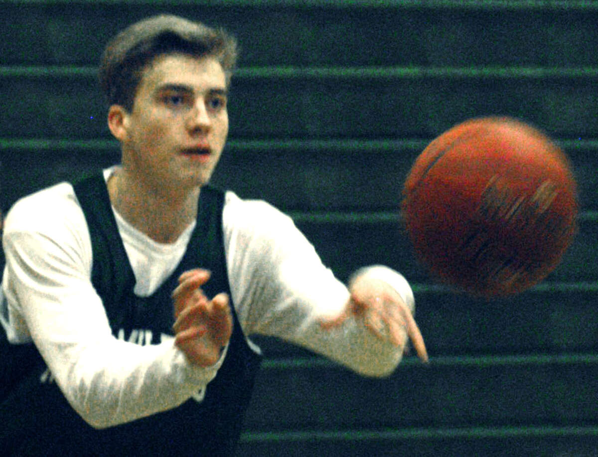 Joey McKay of the Green Wave fires a pass to a teammate during New Milford High School boys' basketball practice, Dec. 5, 2013