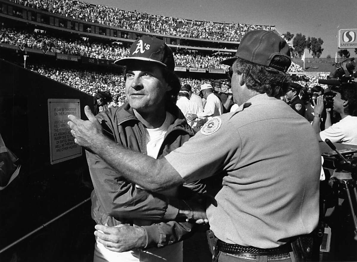 A's manager Tony La Russa accepts congratulations from an Oakland Coliseum security guard after Oakland beat Boston, 3-1, to complete a sweep of the American League Championship Series and move into their third consecutive World Series on October 11, 1990.