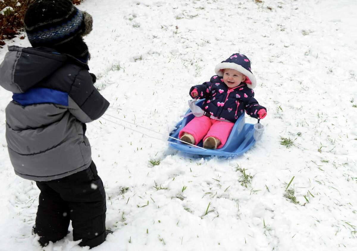 Children play in the snow in Derby, Conn. Tuesday, Dec. 10. 2013.