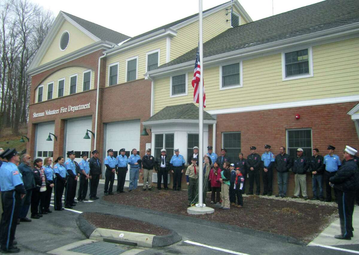 Welcome home! Sherman firefighters and other emergency response volunteers finally have a fully operational emergency services facility to call home. The much-anticipated flag raising and ribbon-cutting ceremony for the town's expanded and renovated facility along Route 39 North was attended Sunday, Dec. 8, 2013 by more than 200 residents. Above, a color guard of youths raises the flag to start off Sunday's festivities. For more photos, see the Dec. 20 edition of The Spectrum and updates at www.newmilfordspectrum.com.