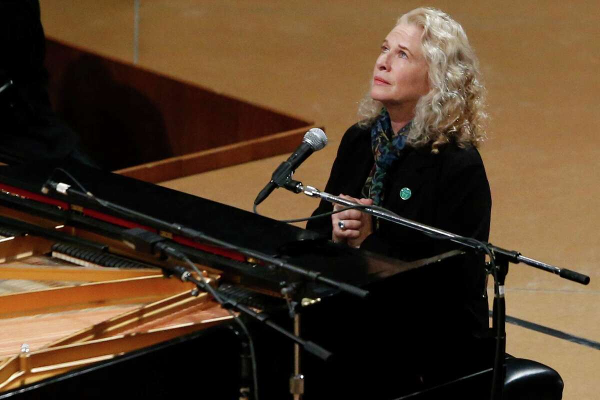 Singer Carole King puts her hands together after performing at a vigil for victims of the shooting at Sandy Hook Elementary School in Newtown, Conn. and other victims of gun violence, Thursday, Dec. 12, 2013, at the National Vigil for Victims of Gun Violence at the National Cathedral in Washington. The one year anniversary of the Newtown, Conn. shootings is December 14.