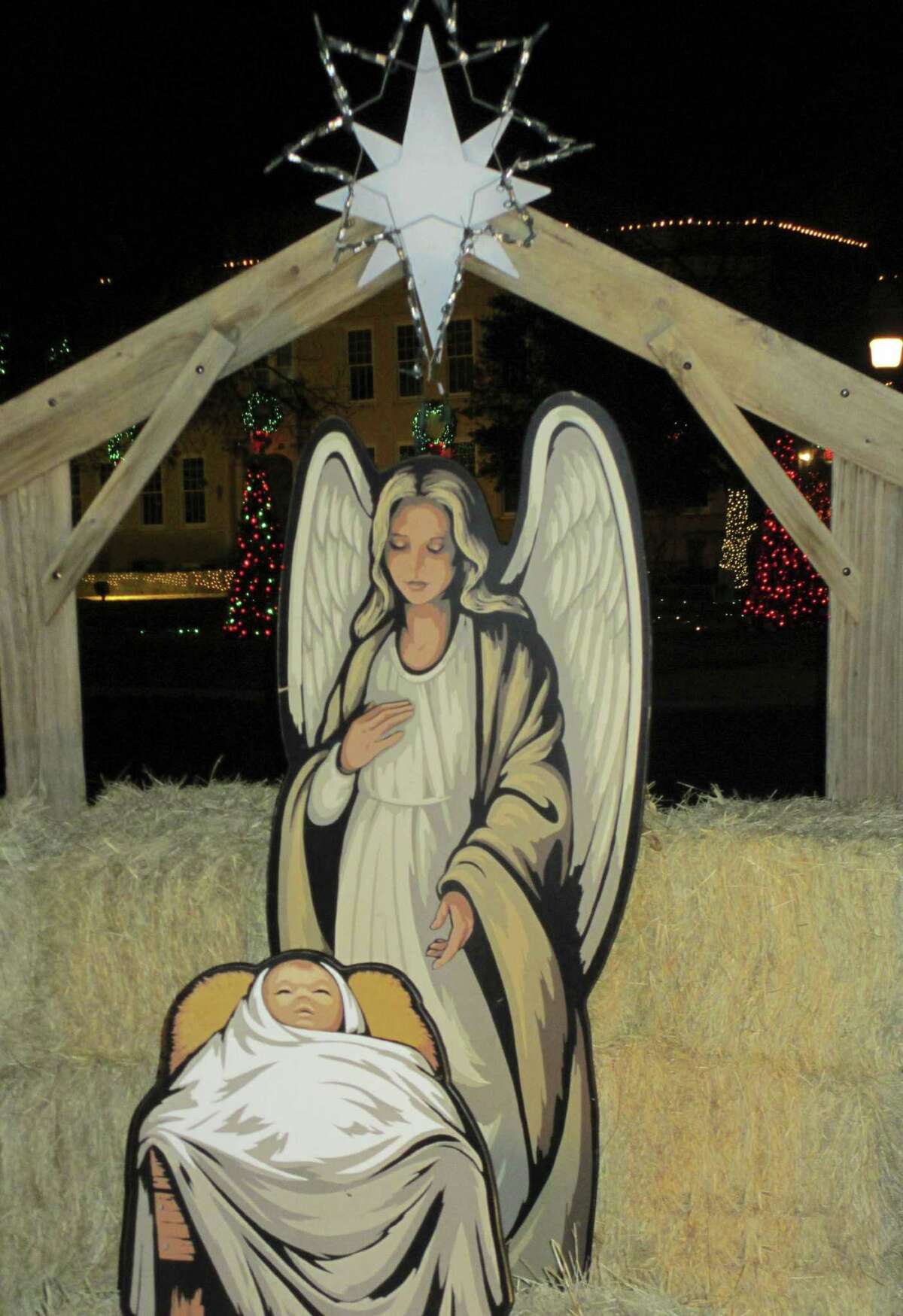 The manger scene on the Kerr County Courthouse Square is beautifully painted and illuminated with spotlights.