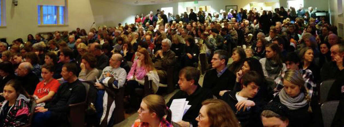 An overflow crowd of several hundred people filled Town Hall's auditorium, a few days after the Sandy Hook Elementary School shooting last December, to attend a vigil organized by the Interfaith Clergy Association.