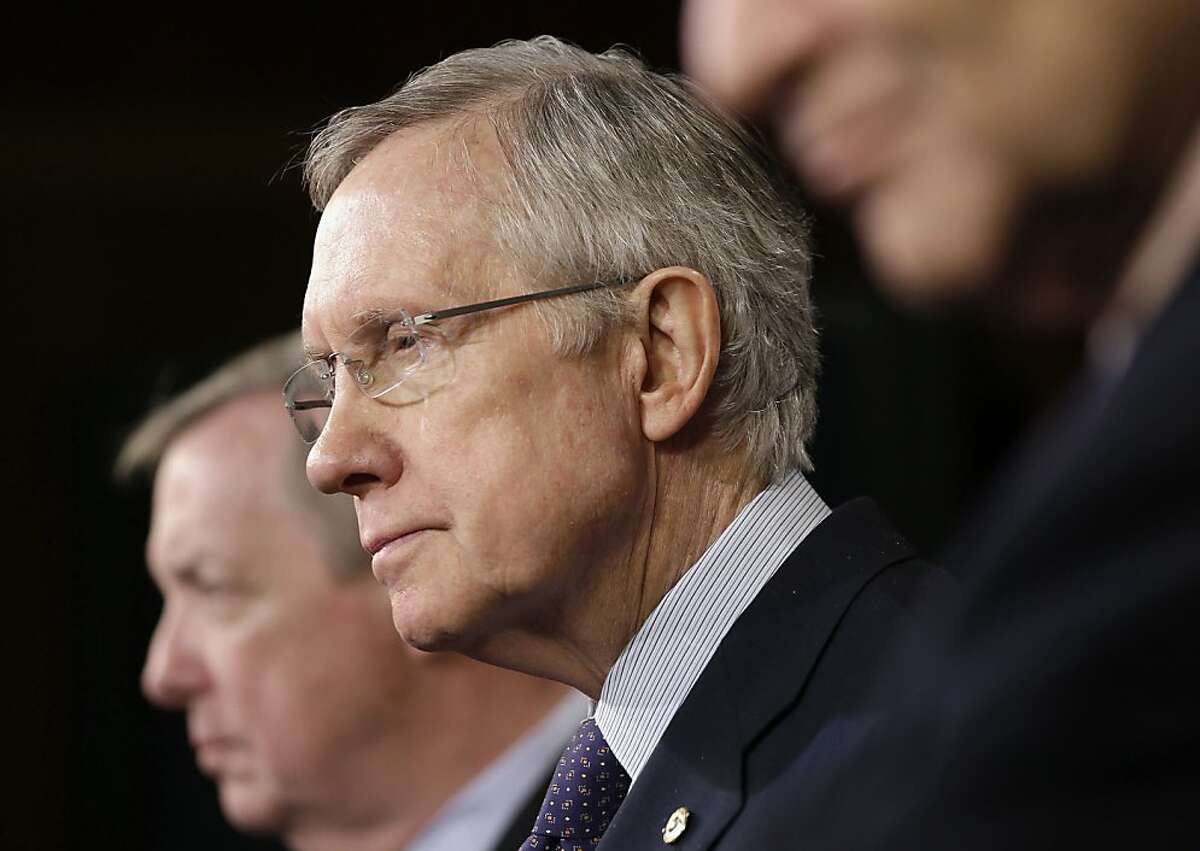 Senate Majority Leader Harry Reid of Nev., center, flanked by Senate Majority Whip Richard Durbin of Ill., left, and Sen. Charles Schumer, D-NY., right, the Democratic Policy Committee chairman, listens during a news conference on budget, Thursday, Dec. 12, 2013, on Capitol Hill in Washington. (AP Photo/Pablo Martinez Monsivais)