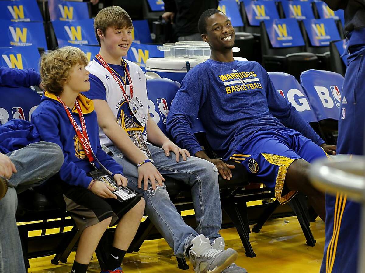 Cole Vitiritto (center), his brother Luke (left) and Harrison Barnes sat together and chatted with a teammate on the Warriors bench before the game Wednesday December 11, 2013 in Oakland, Calif.The Warriors Harrison Barnes welcomed Cole Vitiritto and his family to the Dallas game. Cole is suffering from Osteosarcoma and is a big basketball fan. Both Barnes and Cole are from Iowa.
