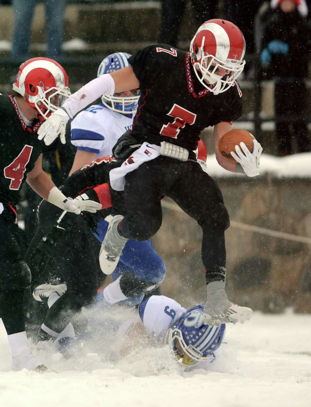 New Canaan's Alexander LaPolice escapes a tackle on his way to a touchdown during the Class L state championship game against Darien on Saturday, Dec. 14, 2013 at Boyle Stadium in Stamford, Conn.