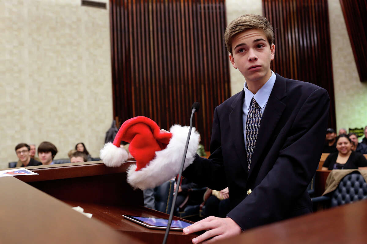 Chief Prosecutor Max Raymond questions Kris Kringle, also know as Santa Claus or Bob Raymond, his father, during Santa's trial in the John H. Wood, Jr. U.S. Courthouse in San Antonio on Saturday, Dec. 14, 2013. Santa was tried for a violation of a statue concerning separation of Church and State for delivering presents at Bonham Elementary School.