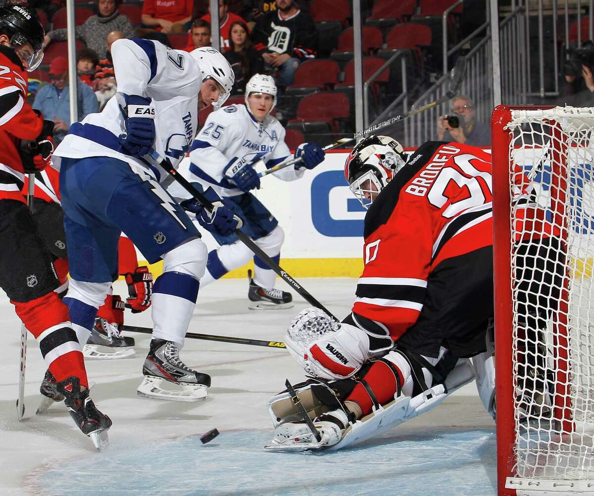 NEWARK, NJ - DECEMBER 14: Goalie Martin Brodeur #30 of the New Jersey Devils makes a save on a shot by Alex Killorn #17 of the Tampa Bay Lightning during the first period of an NHL hockey game at Prudential Center on December 14, 2013 in Newark, New Jersey. (Photo by Paul Bereswill/Getty Images) ORG XMIT: 181112066