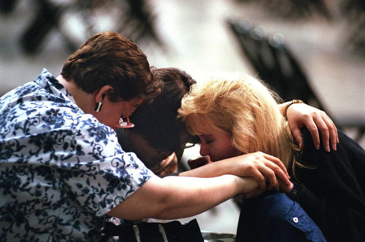 Counselors Linda Nickens (from left), Sun Hee Lien and Jenny Darnell huddle together in prayer before the start of the first service of the Billy Graham Crusade in San Antonio on Thursday, April 3, 1997.