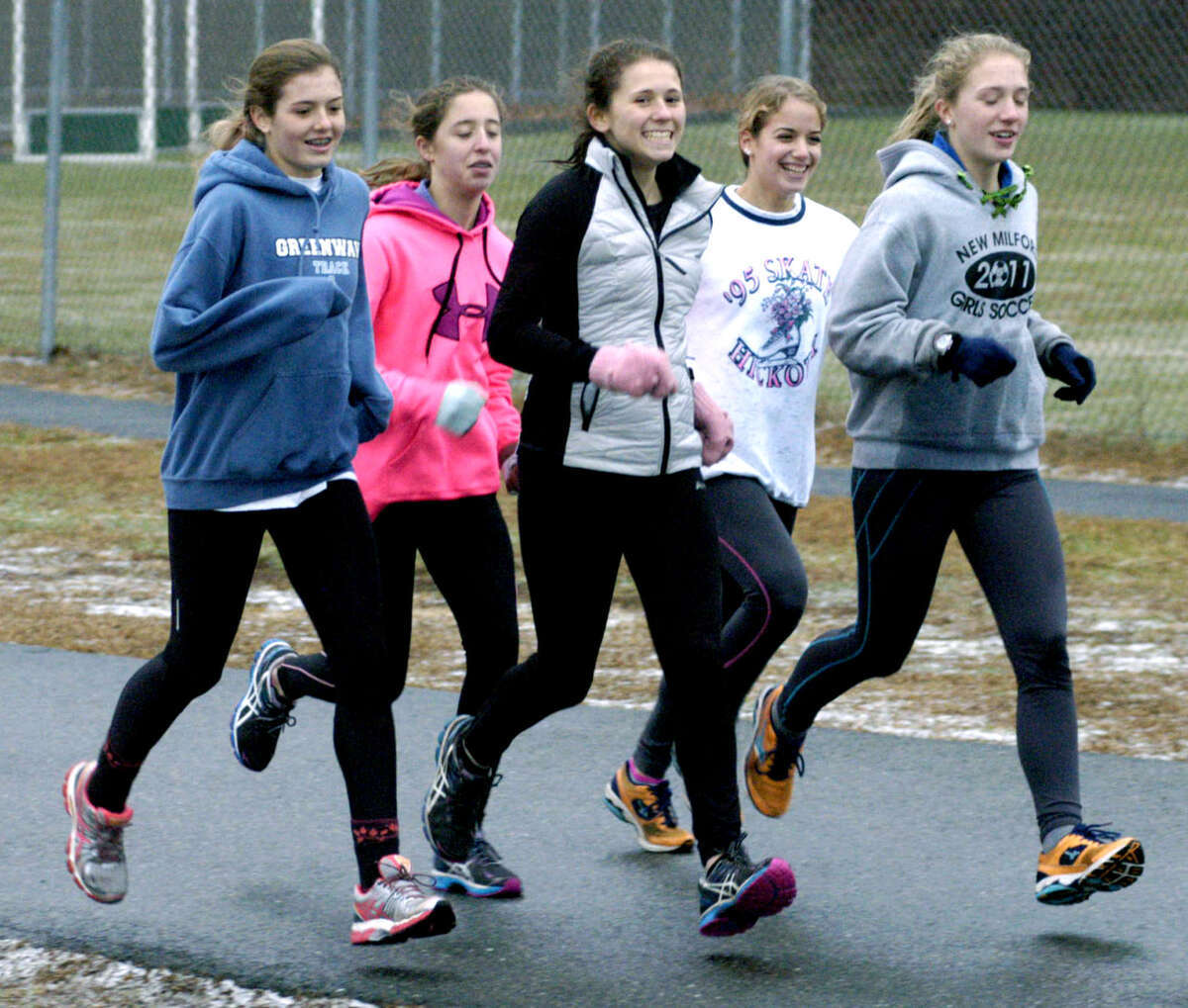 Green Wave runners, from left to right, Hannah Tower, Greer Kramer, Emily Day, Nicole McCarthy and Helen Bayers enjoy a workout Dec. 9 during New Milford High School girls' indoor track practice. Dec. 9, 2013