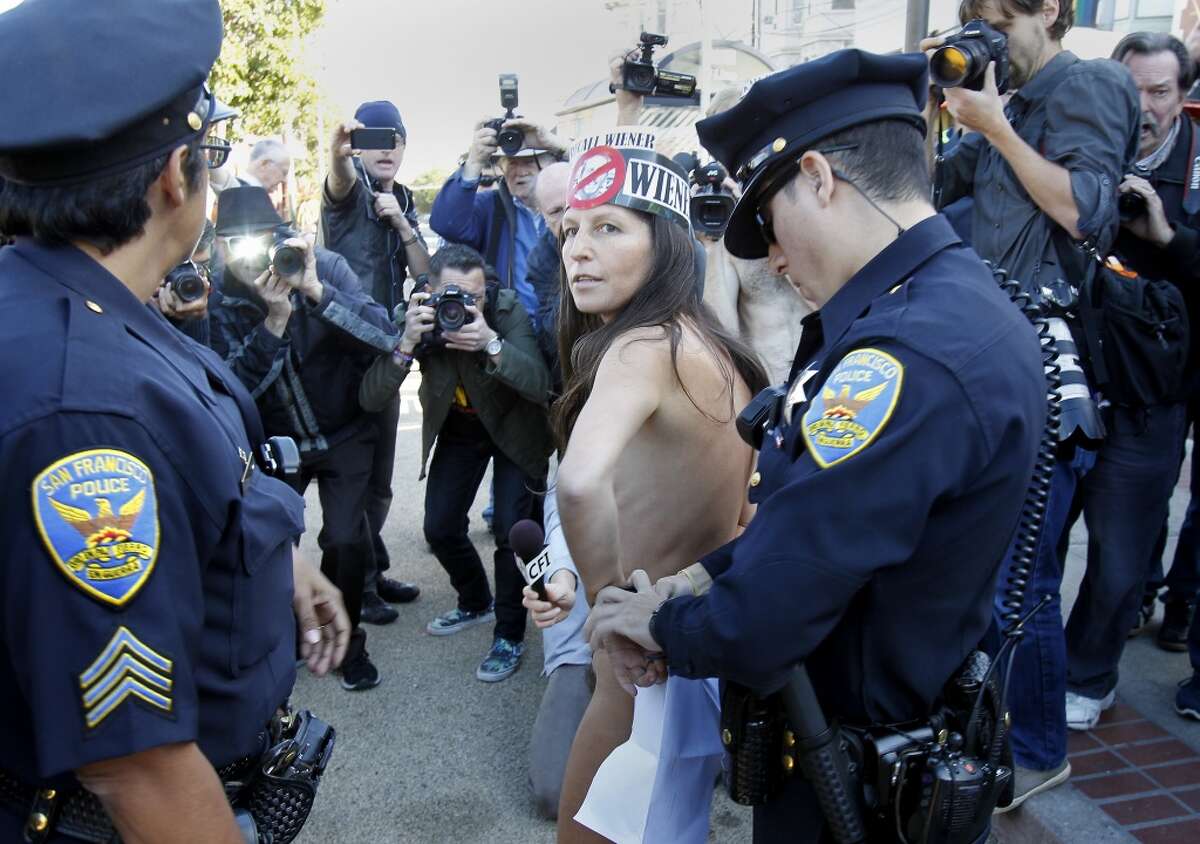 Gypsy Taub, who led the rally, is handcuffed by police Sunday November 17, 2013 in San Francisco, Calif. Police arrested and cited a group of nudists who staged a rally at the corner of Market and Castro Streets, violating the city's nudity ban.
