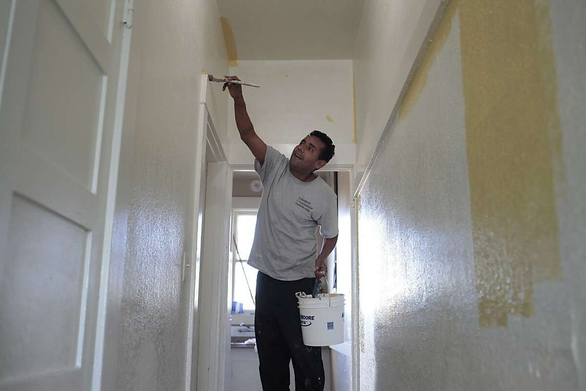 Raul Rivas paints his home in Oakland, Calif. on Saturday, Dec. 14, 2013. Rivas suffered from lead exposure while working for Winnings Colors and recently won a lawsuit against them for not providing protection against exposure.
