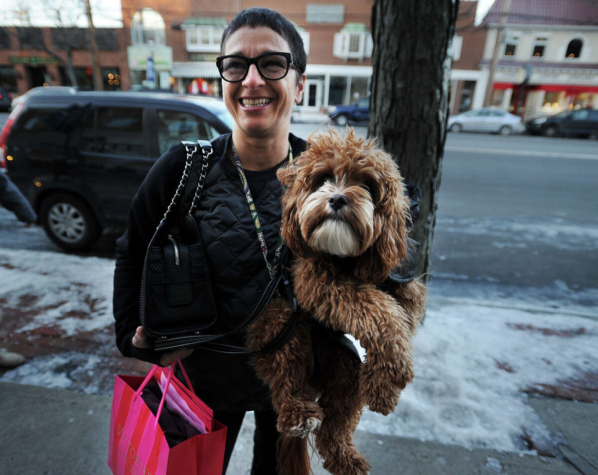 Chiara Rudzin of Westport and Rudy Rags, her Cavapoochon, do some holiday shopping on the Post road in Downtown Fairfield, Conn. on Monday, December 16, 2013.