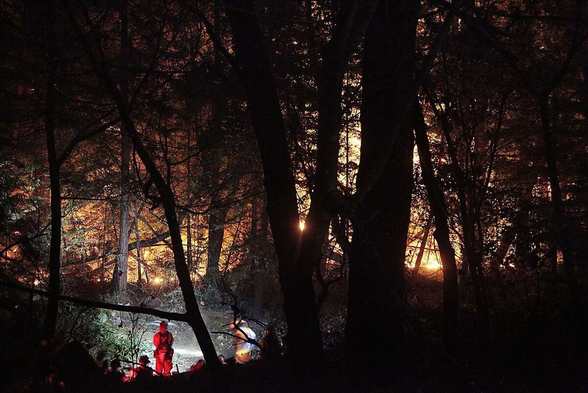 Firefighters work late into the night to contain a wildfire in Big Sur on Monday. A wildfire in Big Sur began yesterday morning and has burned more than 500 acres.