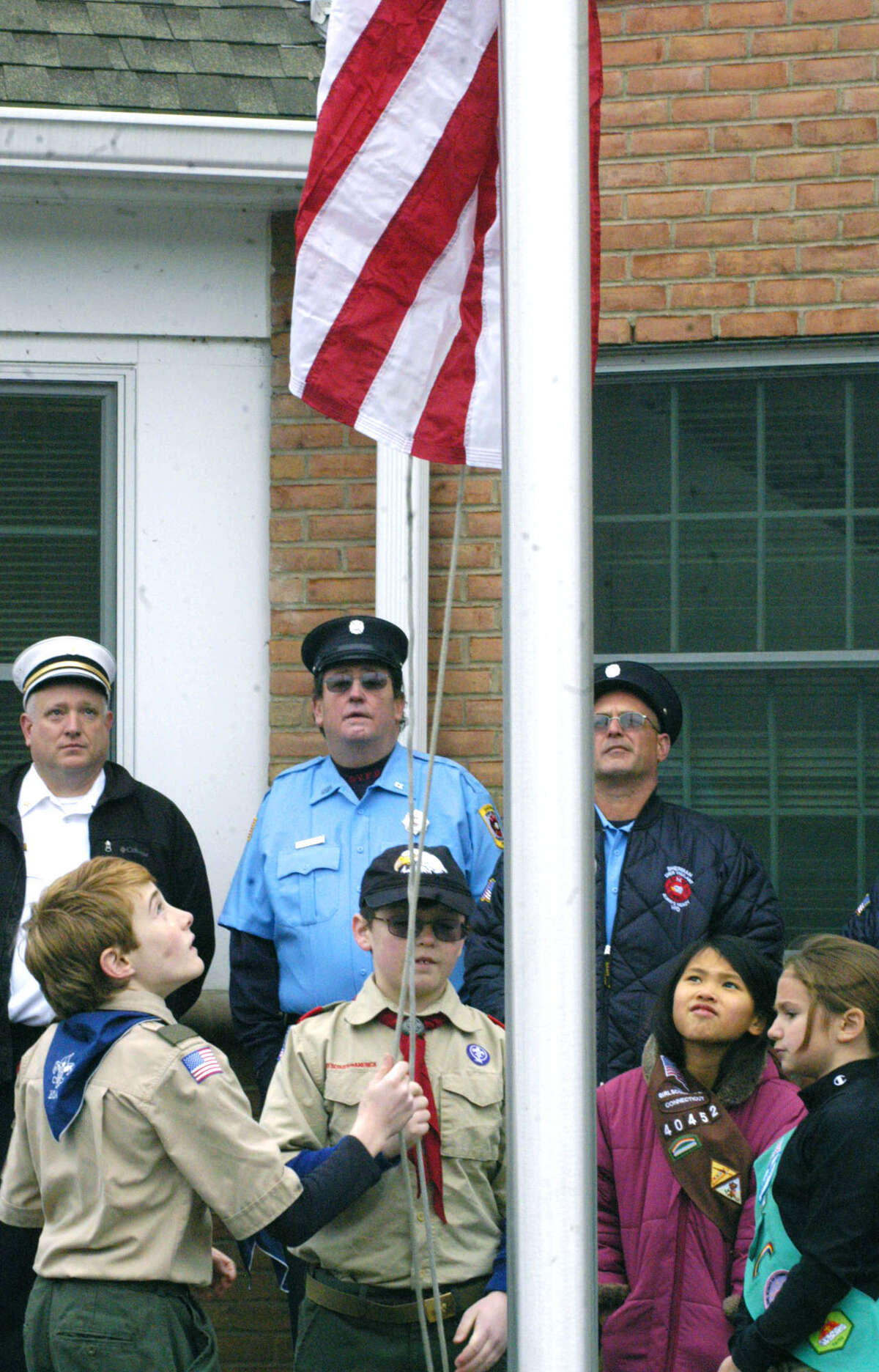 Boy Scouts and Girls Scouts participate in the flag-raising ceremony to kick off Sherman's Dec. 8, 2013 festivities celebrating the official opening of the town's renovated and expanded firehouse, now known as the emergency services facilty. The youths are, from left to right, Michael Tarby, Patrick Dwyer, Micayla Tarby and Molly Fazzone. Active in the ceremony but not shown are Andy Fazzone and Nick and Brendan Sartori.