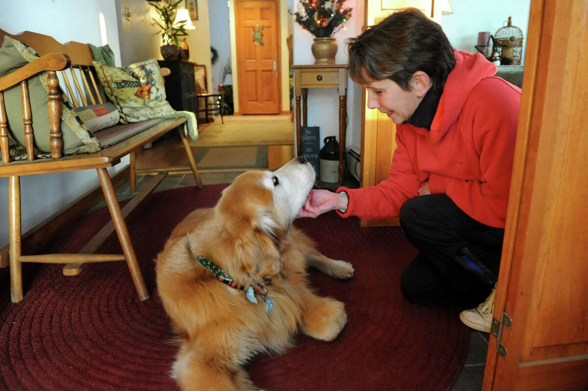 Cindy Diamond and Riley, her Golden retriever, on Friday, Dec. 13, 2013, at their home in Loudenville, N.Y. Riley, 9, has lost 11 pounds since being in a weight loss program. (Cindy Schultz / Times Union)